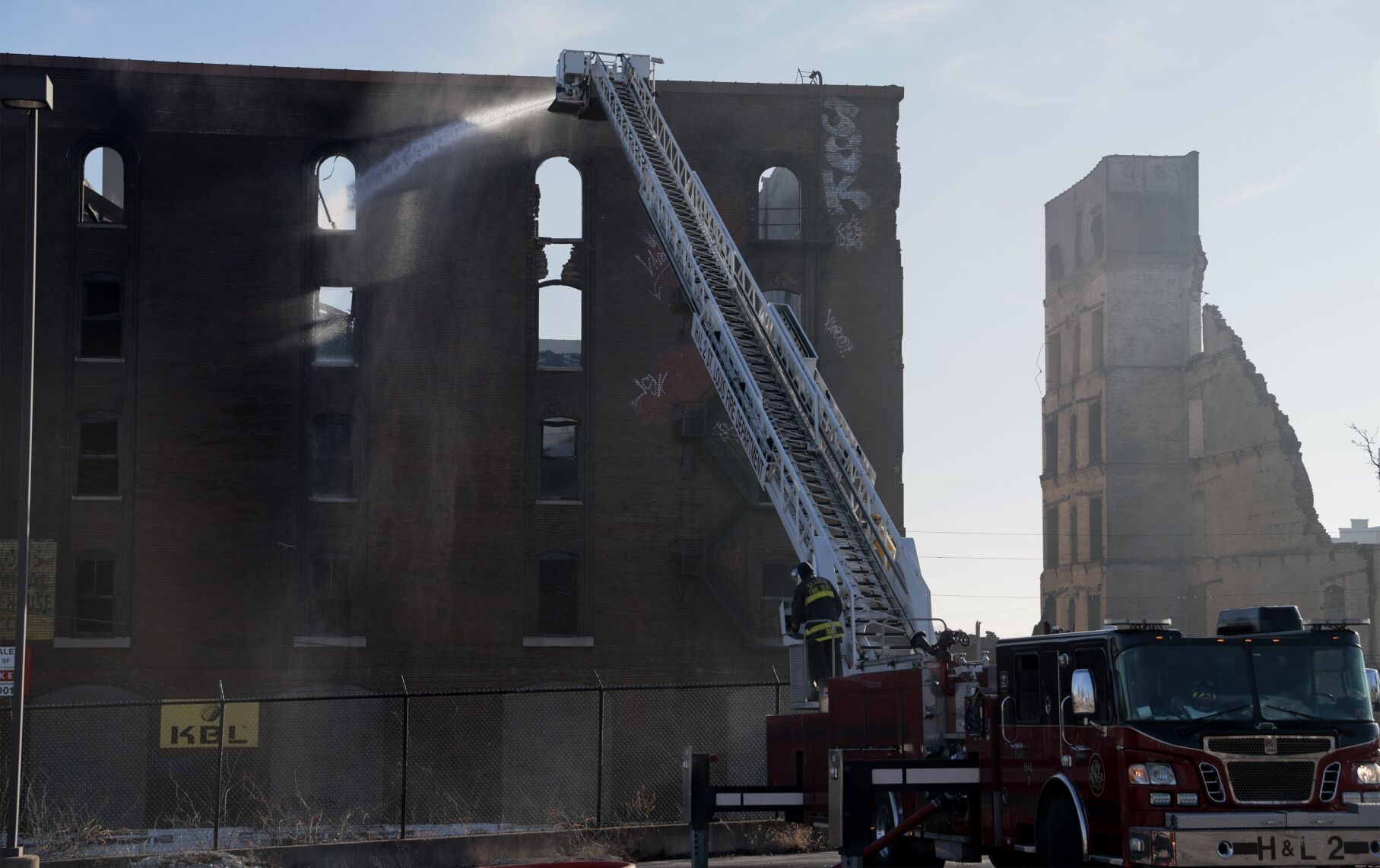 Fire Department still putting water on hot spots from massive warehouse Saturday